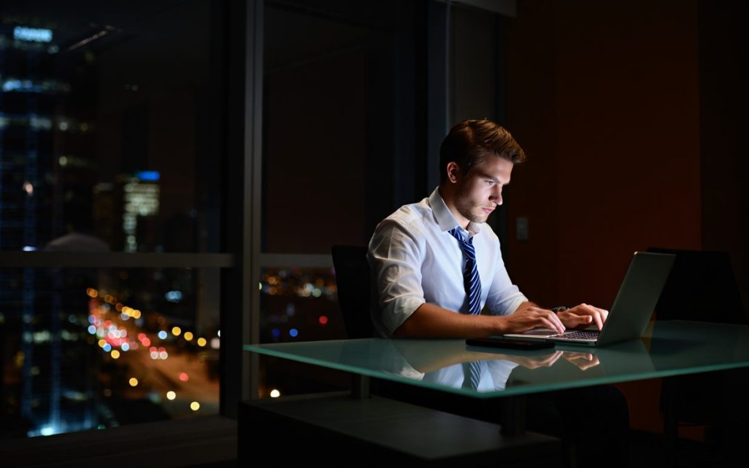 businessman working on a cold calling lead generation list late at night