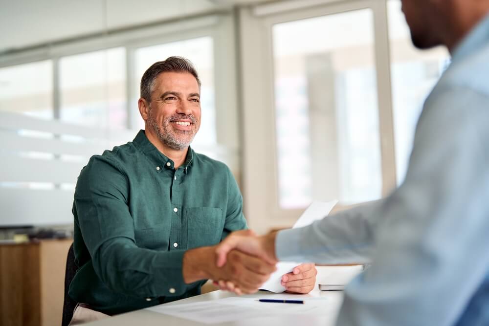 man and woman in a coffee shop discussing sales pipeline management