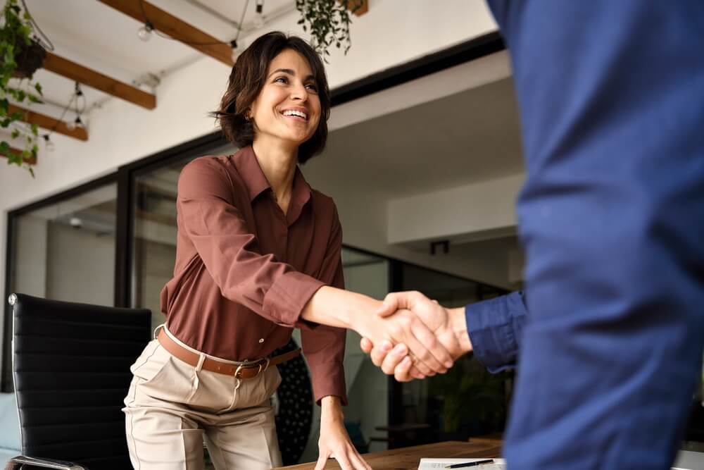 man and woman in a coffee shop discussing sales pipeline management
