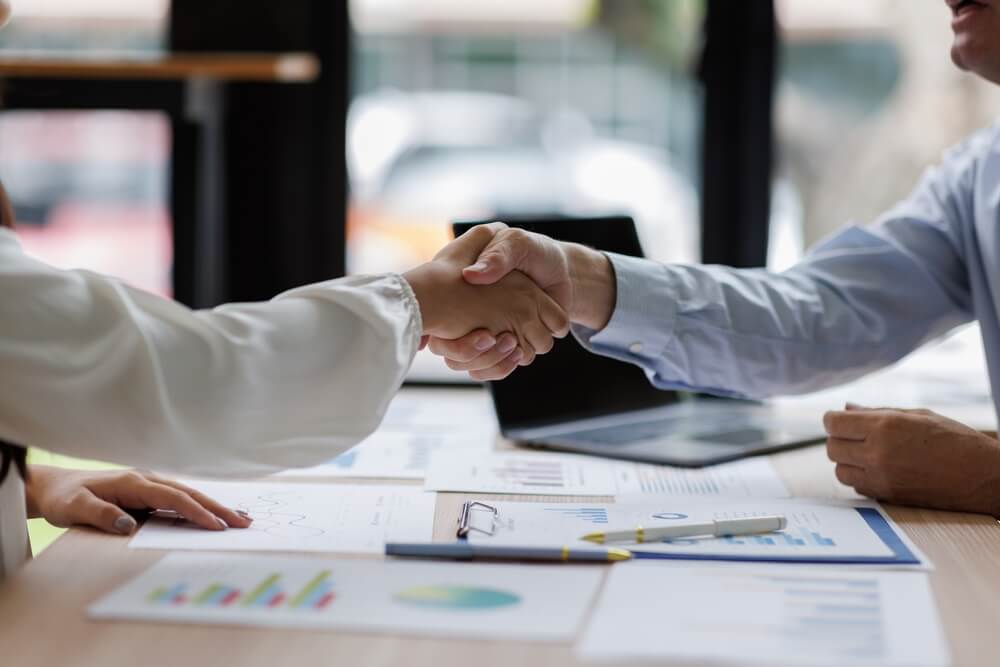 man and woman in a coffee shop discussing sales pipeline management