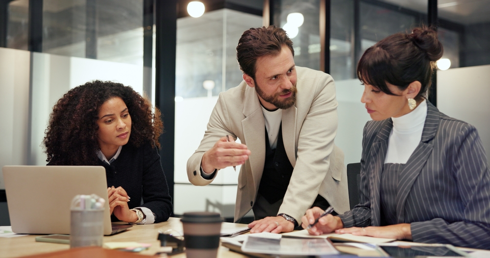man and woman in a coffee shop discussing sales pipeline management